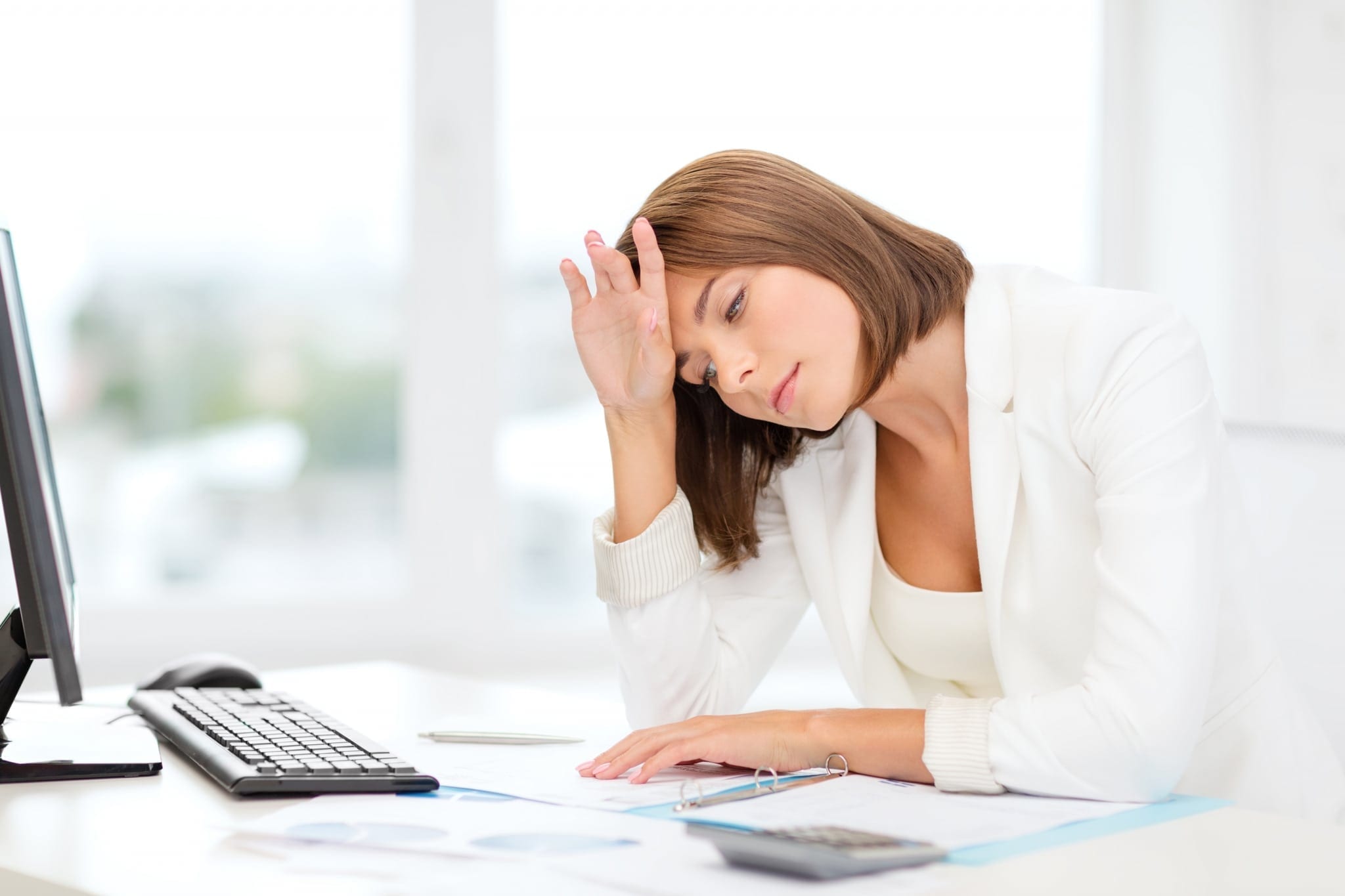 Tired Businesswoman With Computer And Papers